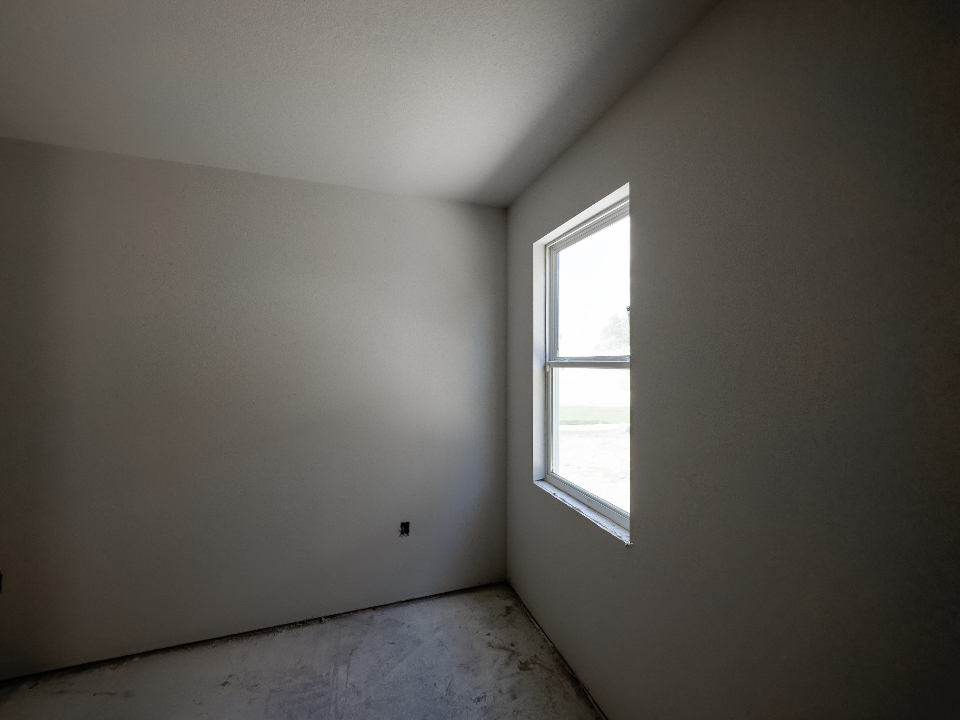 Original: Empty white room (right-wall window, concrete floor, left-wall outlet)